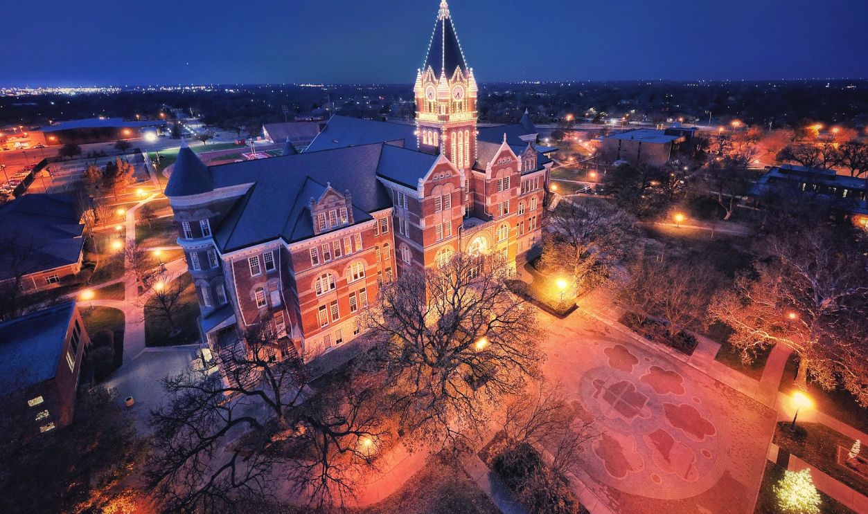 Stunning aerial night view of an illuminated university tower in Wichita, Kansas
