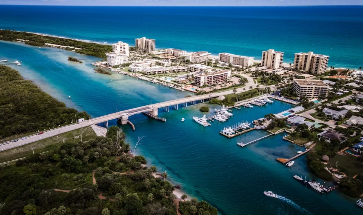 aerial view of city buildings near body of water during daytime
