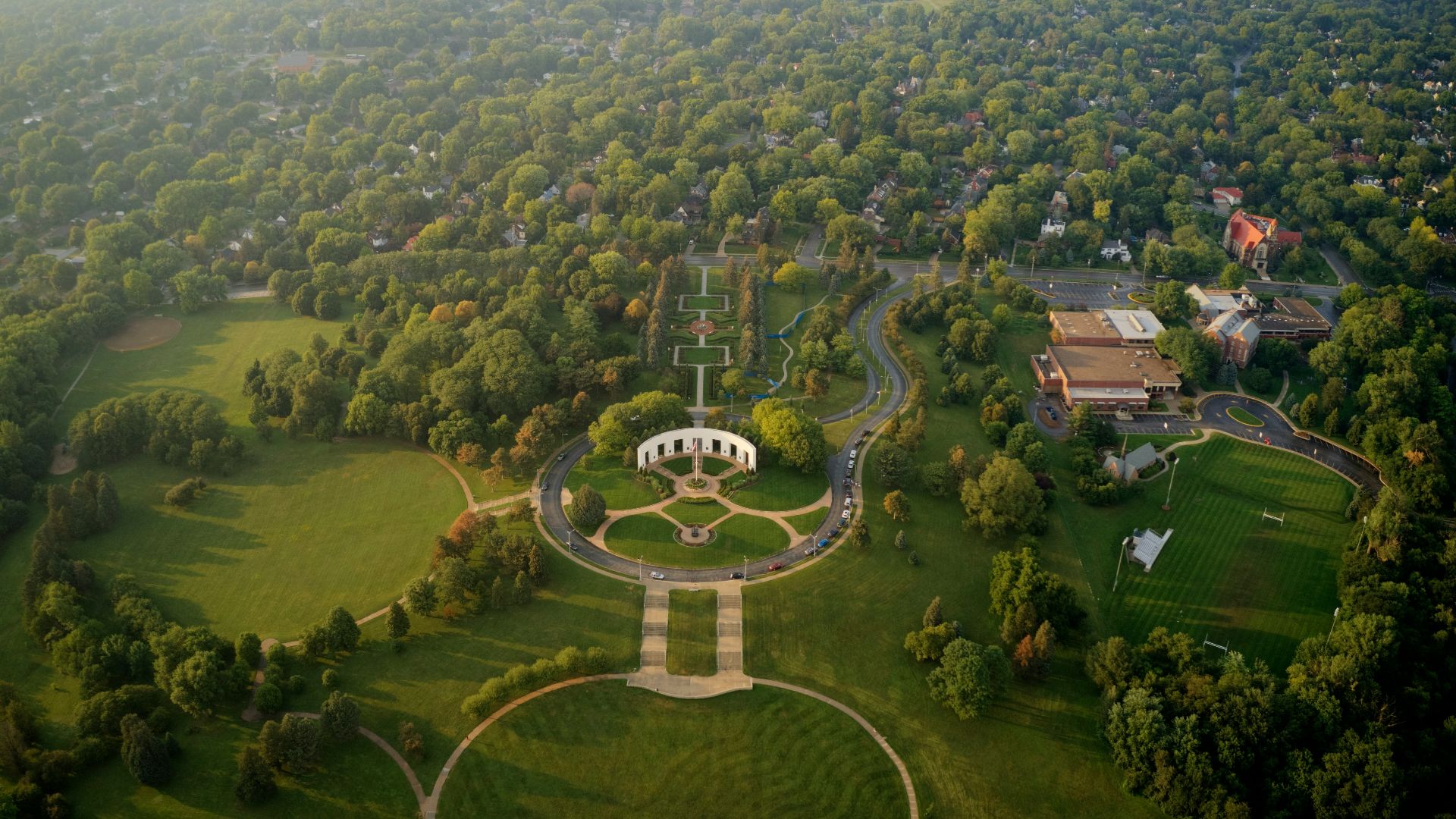 an aerial view of a circular building surrounded by trees