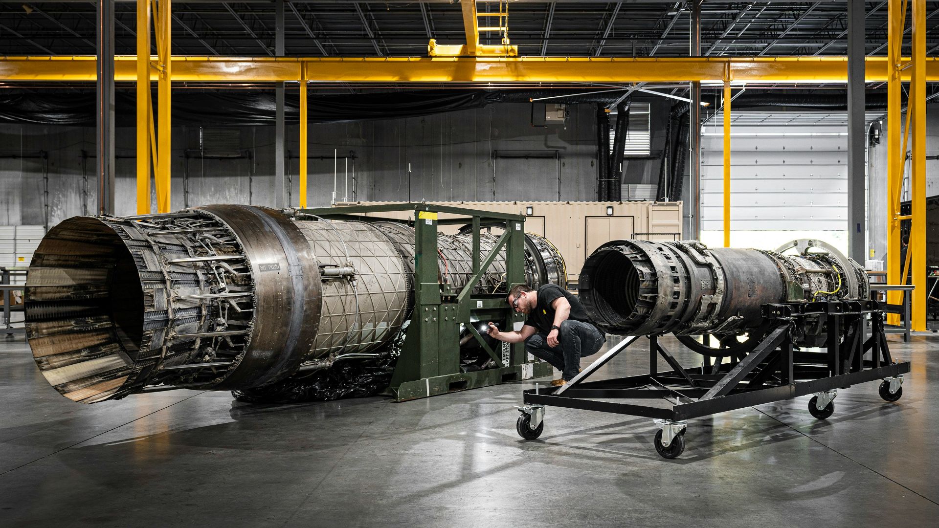 a man working on a large machine in a factory