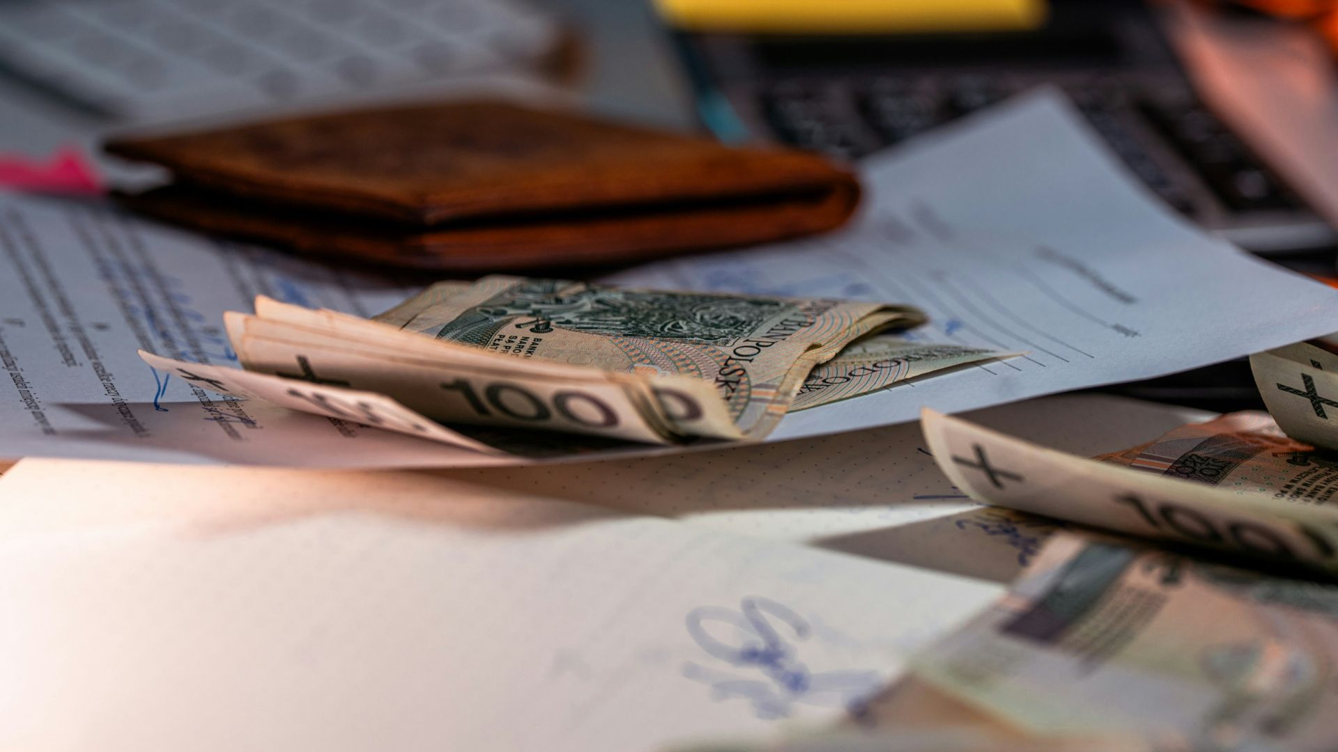 Money and documents on a desk.