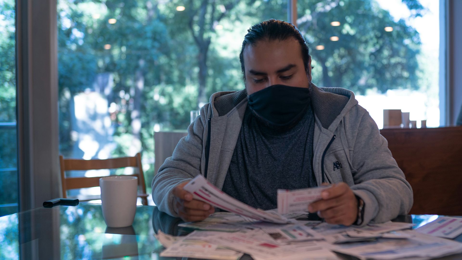 man in gray jacket reading newspaper