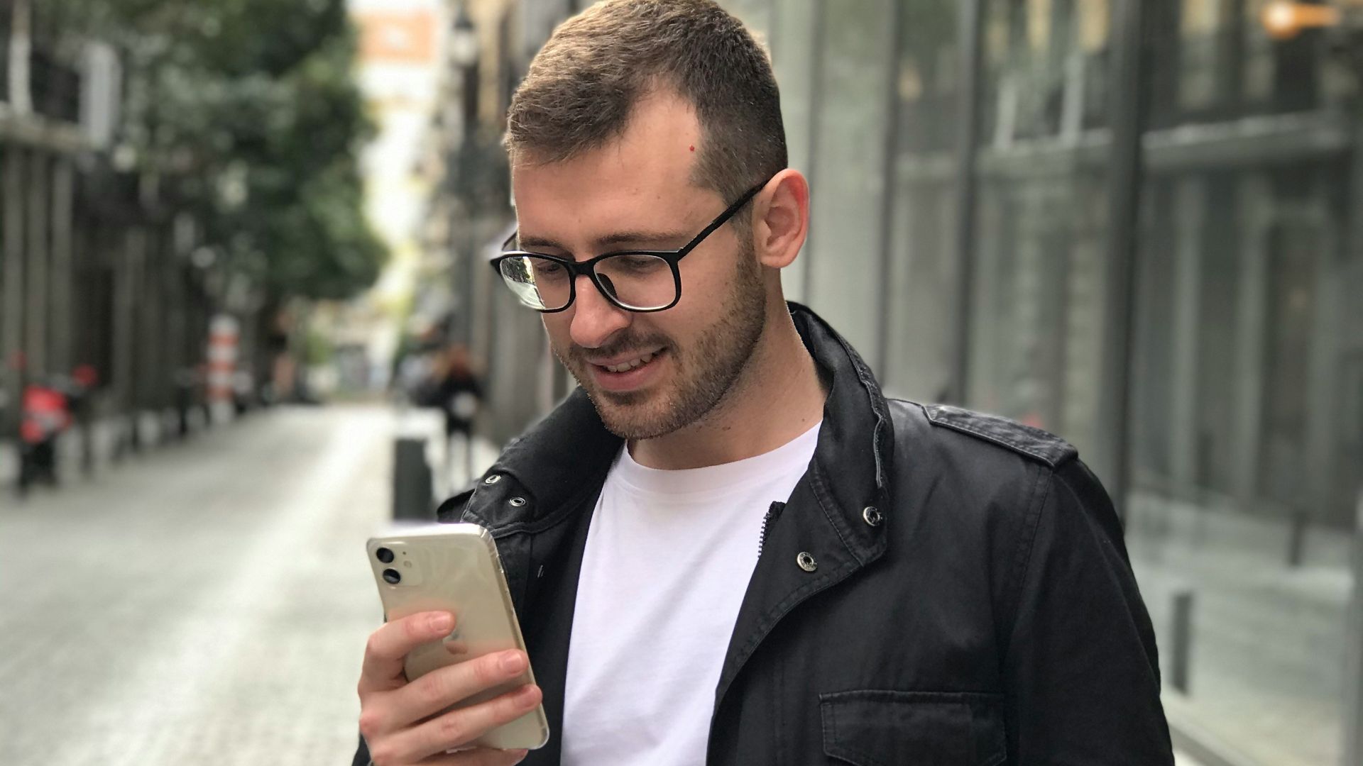 man in black full-zip jacket using smartphone