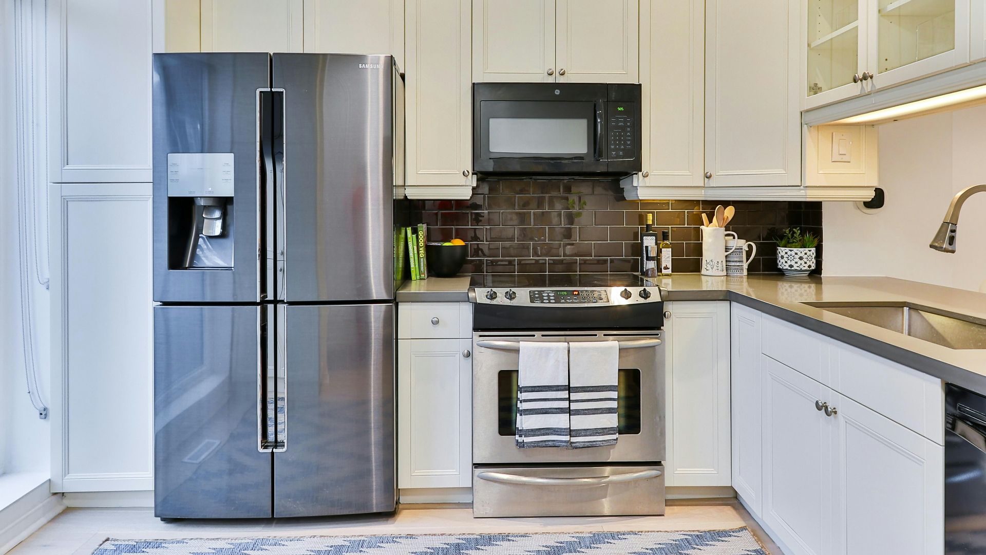 silver french door refrigerator beside white wooden kitchen cabinet
