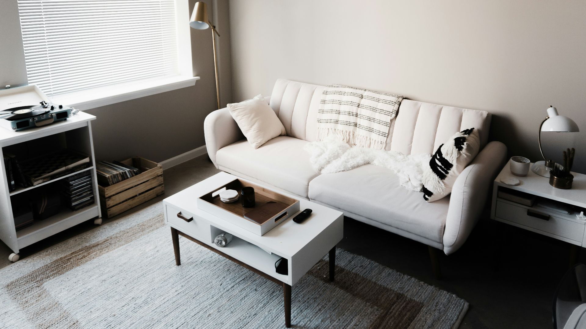 white couch in front of white wooden table