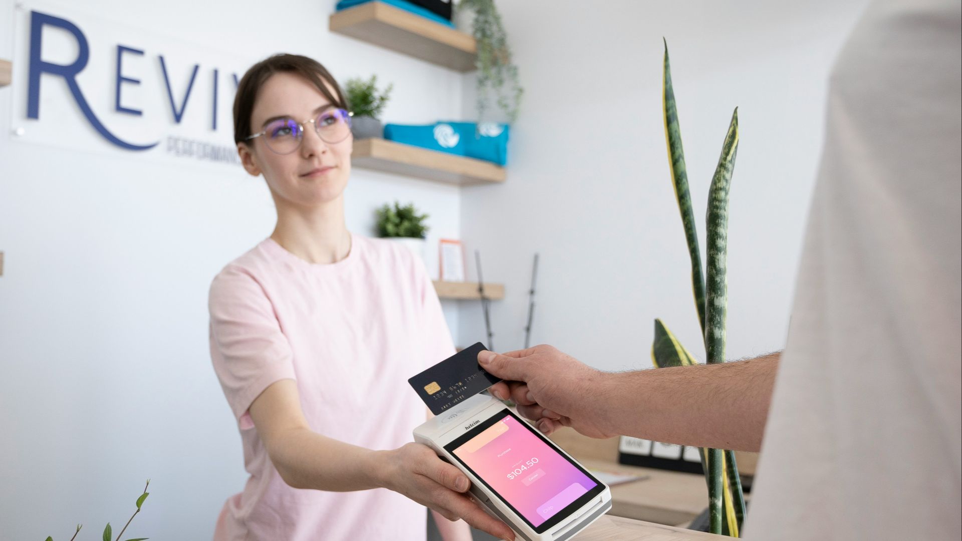 a woman is handing a card to a man