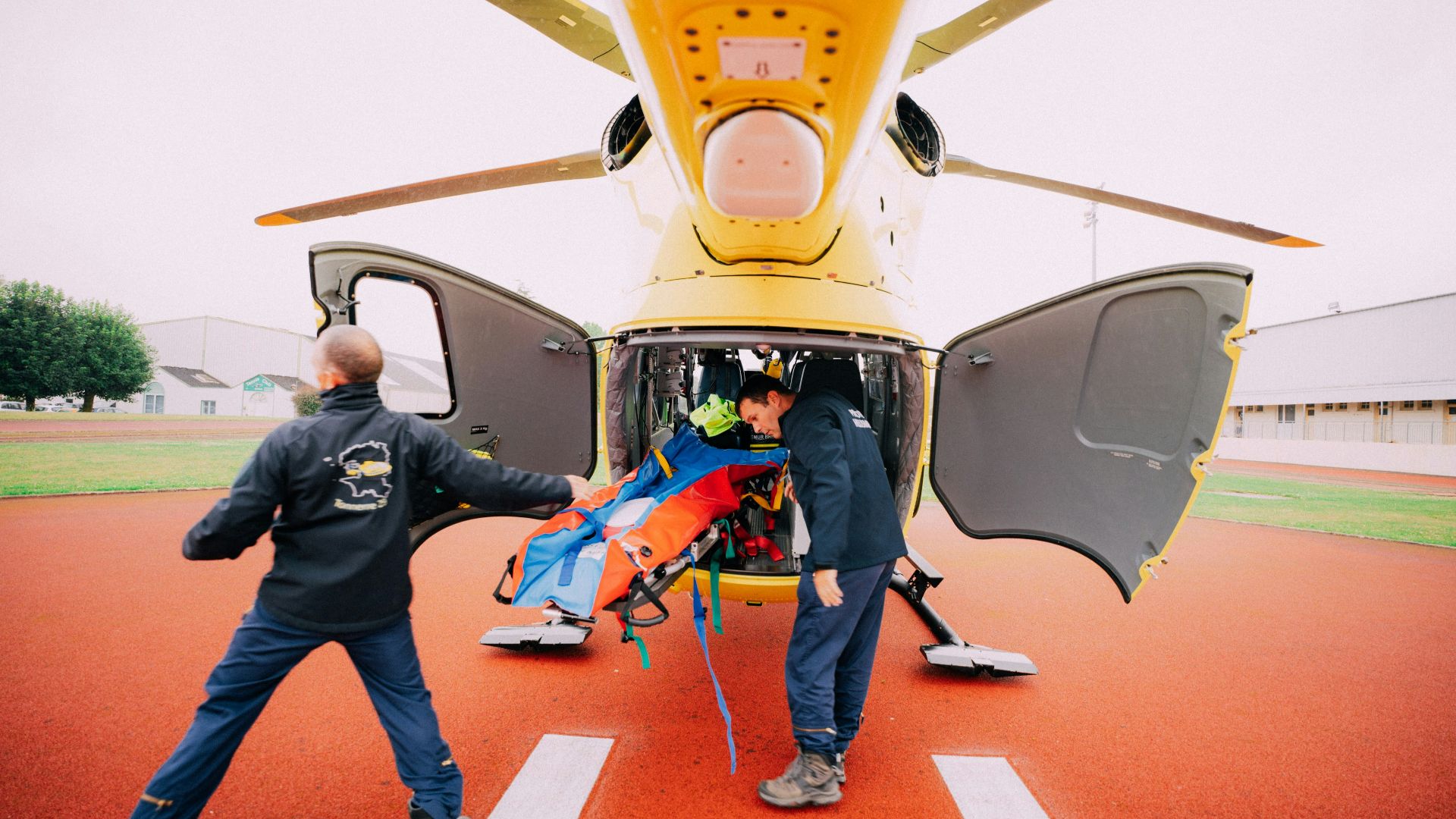 a man is being loaded into the back of a helicopter