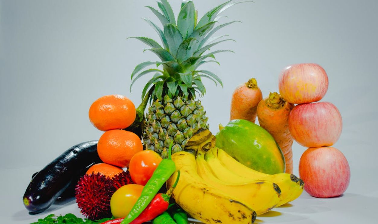A colorful display of fresh tropical fruits and vegetables for healthy eating.