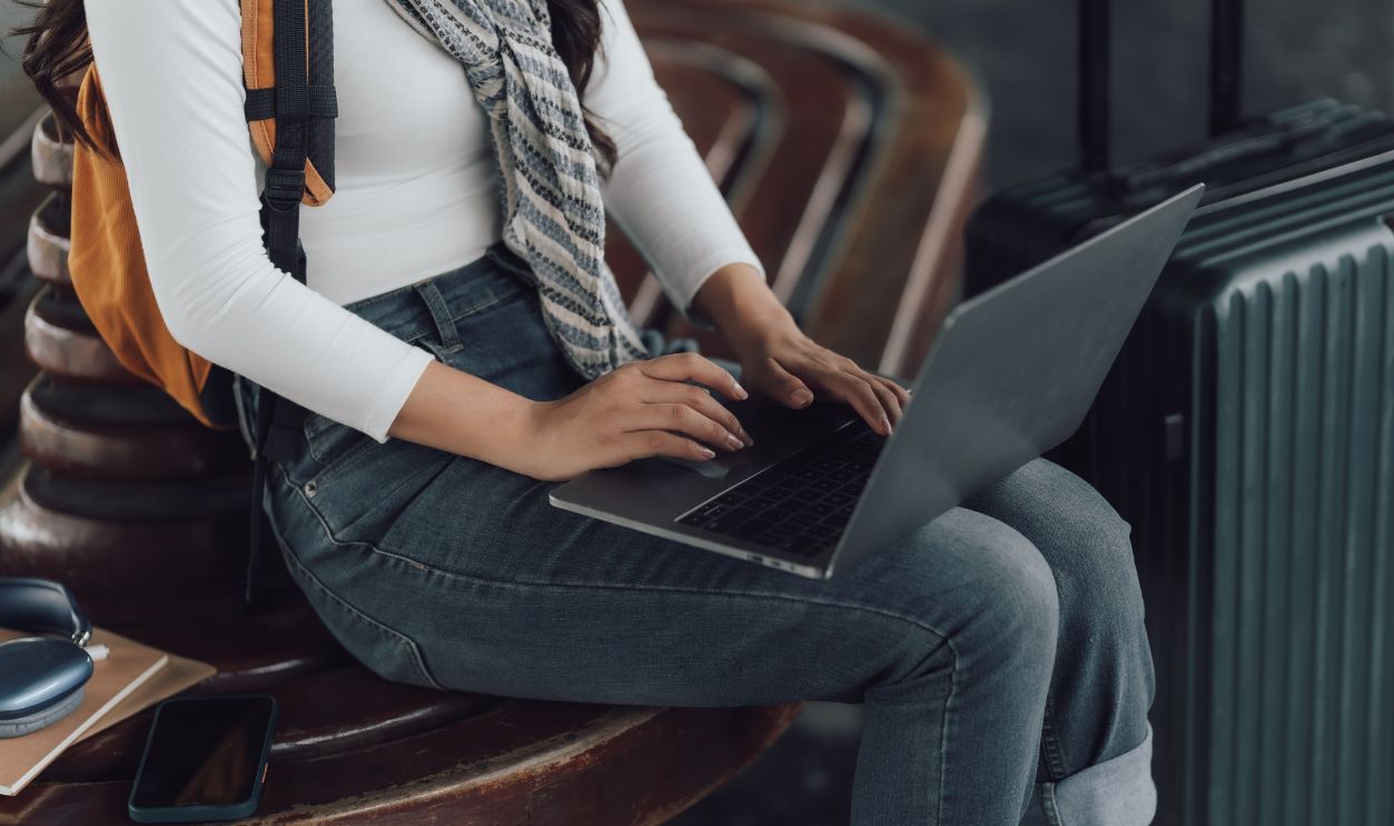 Woman Working on Laptop While Traveling