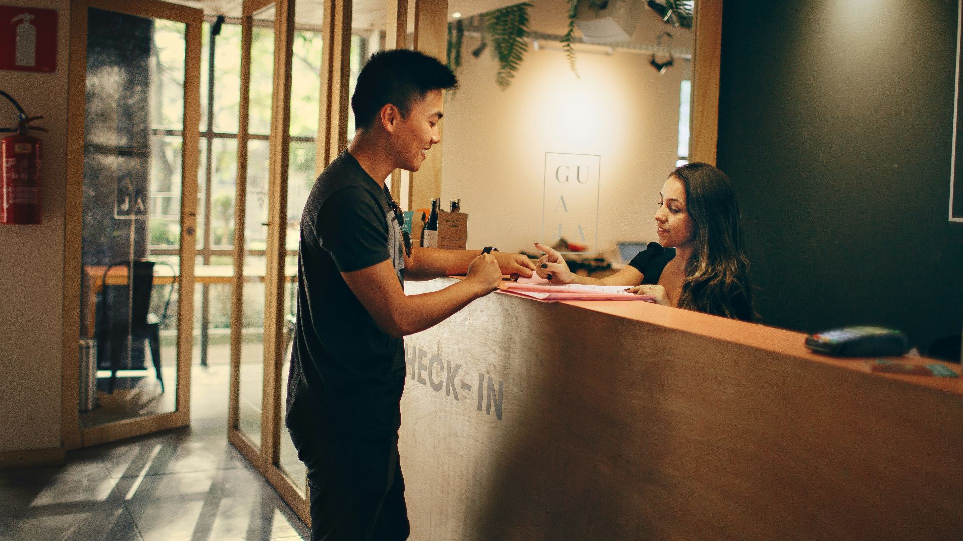 man in black shirt standing beside counter
