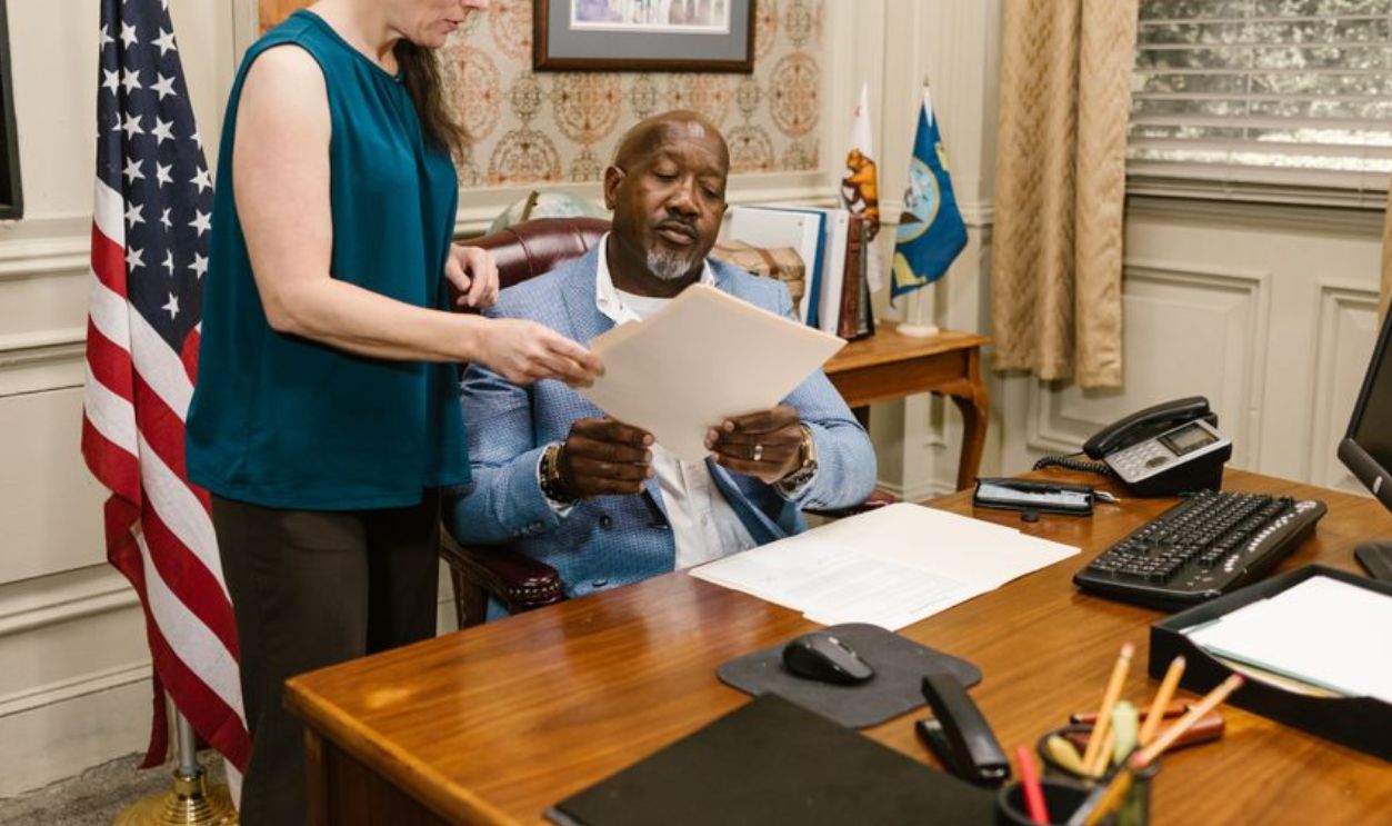 A lawyer and client discuss legal documents in a law office setting, highlighting professionalism and collaboration