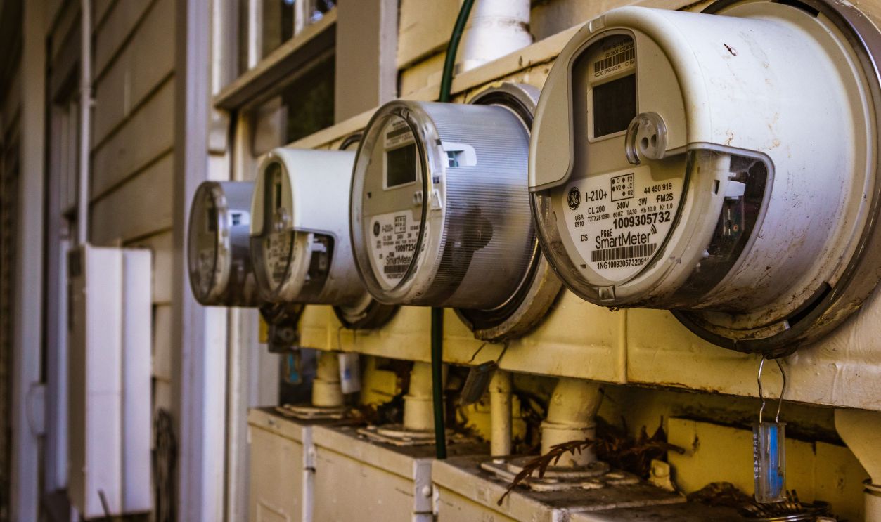 Image of multiple smart electricity meters installed on a residential exterior wall, showing environmental adaptation