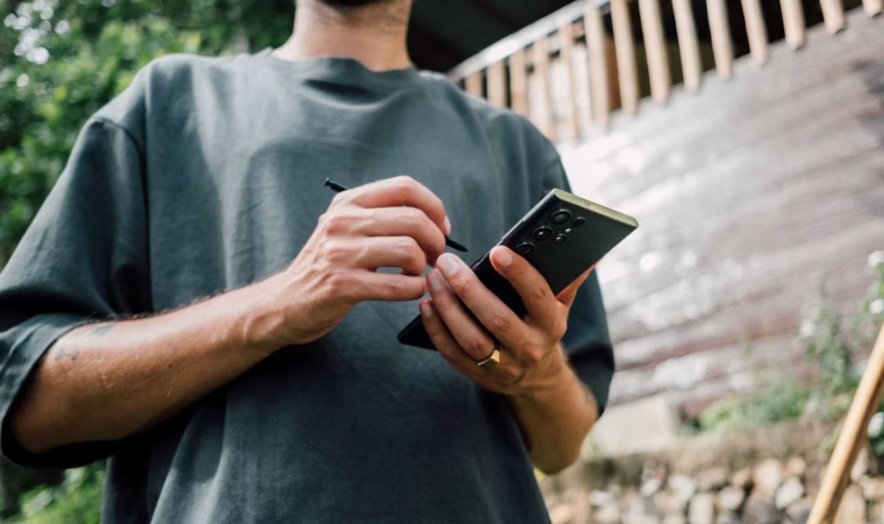 a man holding a cell phone in his hands