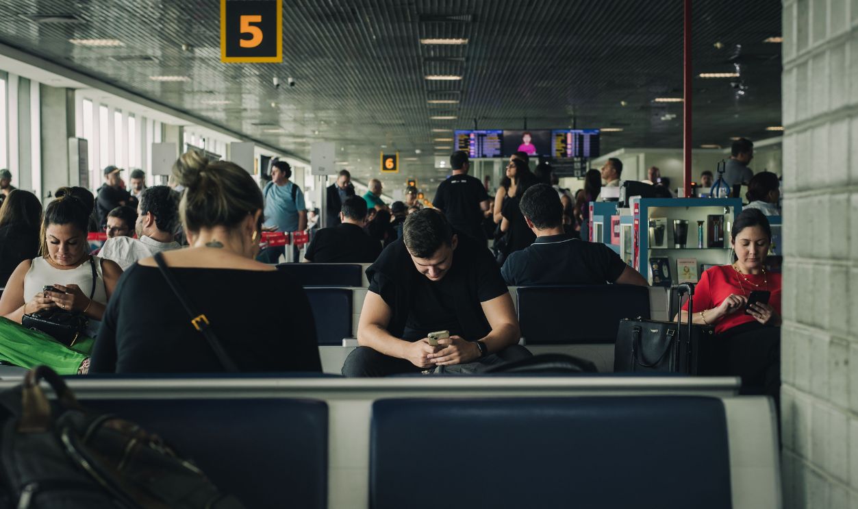 Travelers seated and waiting at São Paulo airport terminal