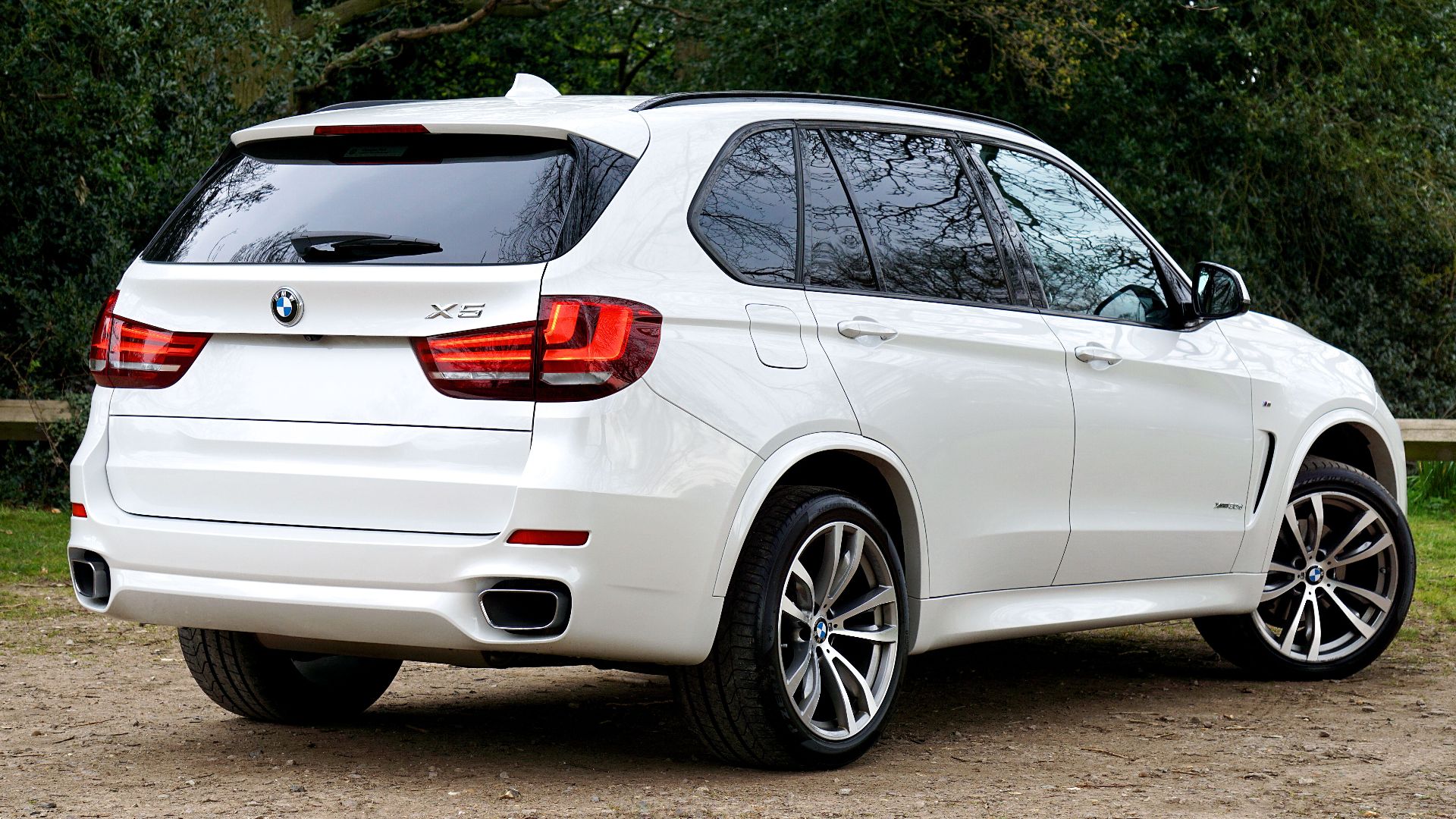 A white luxury SUV parked outdoors, showcasing elegant design and powerful features.