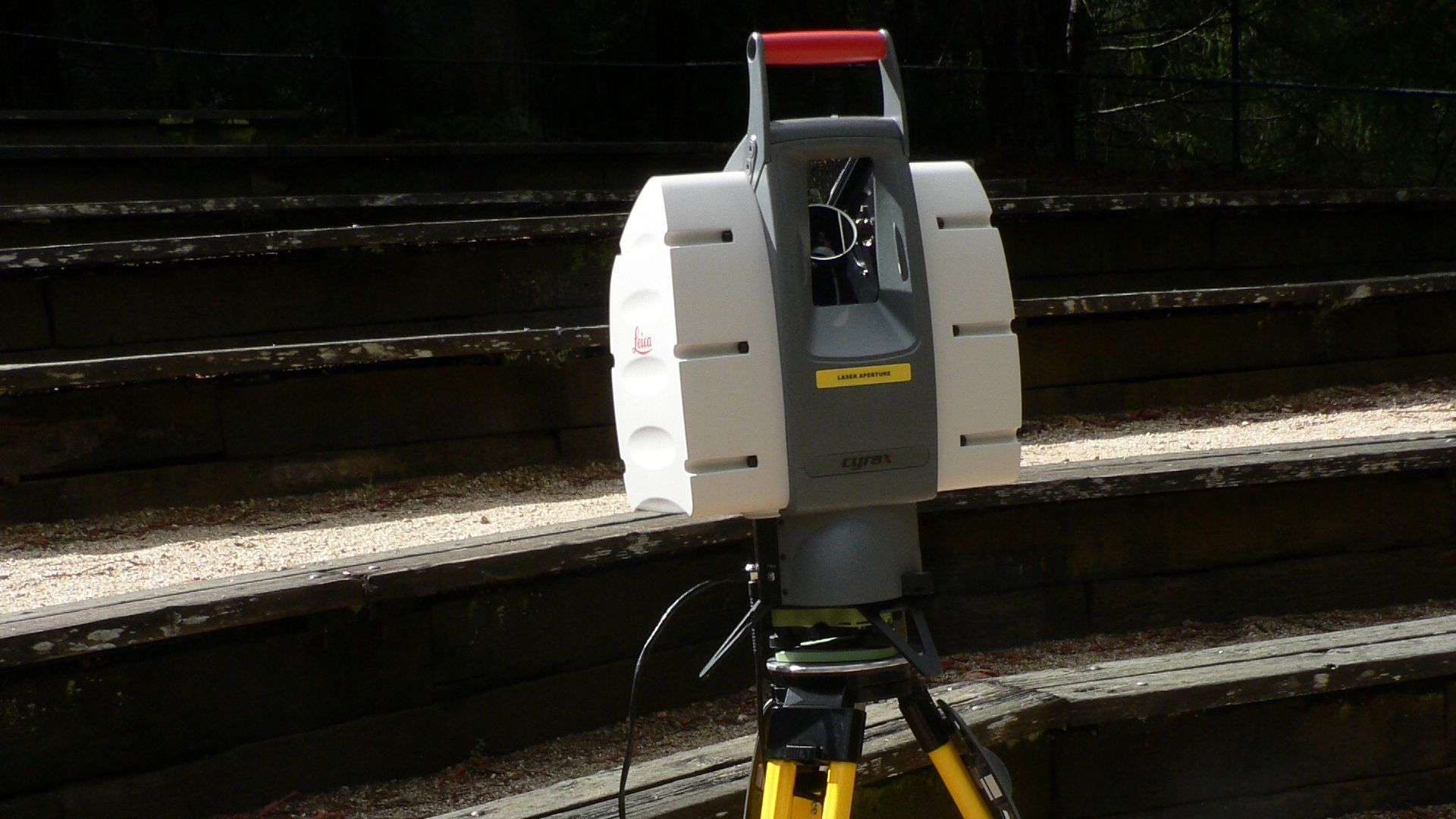 This Leica terrestrial lidar (light detection and ranging) scanner (TLS) may be used to scan buildings, rock formations, etc., to produce a 3D model.
The TLS can aim its laser beam in a wide range: its head rotates horizontally, a miror flips vertically. 