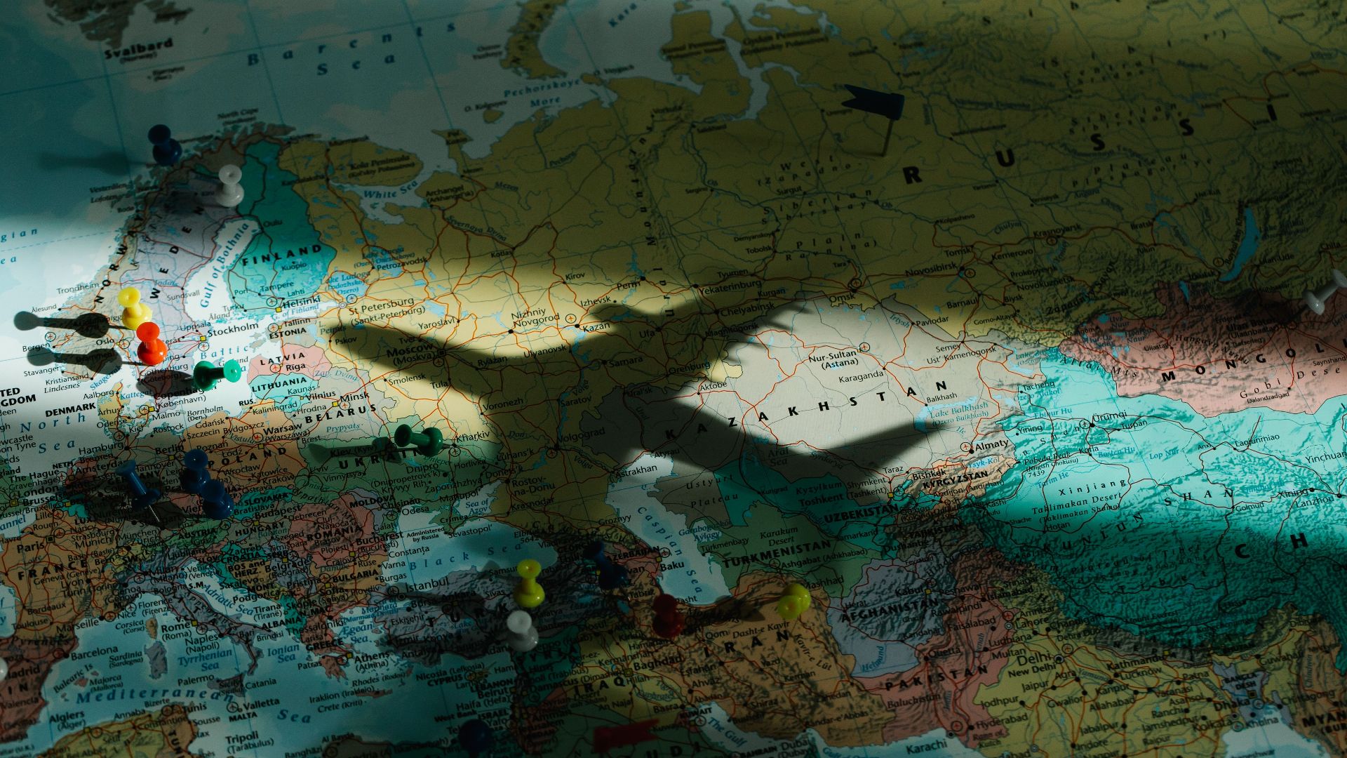 Shadow of an airplane on a map of Europe, highlighting travel and exploration concepts.