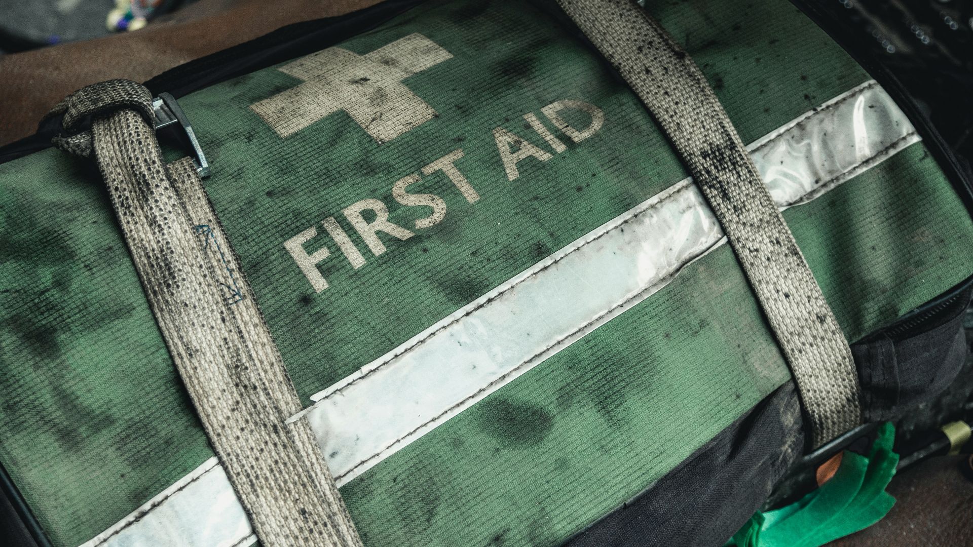 green and black first aid bag