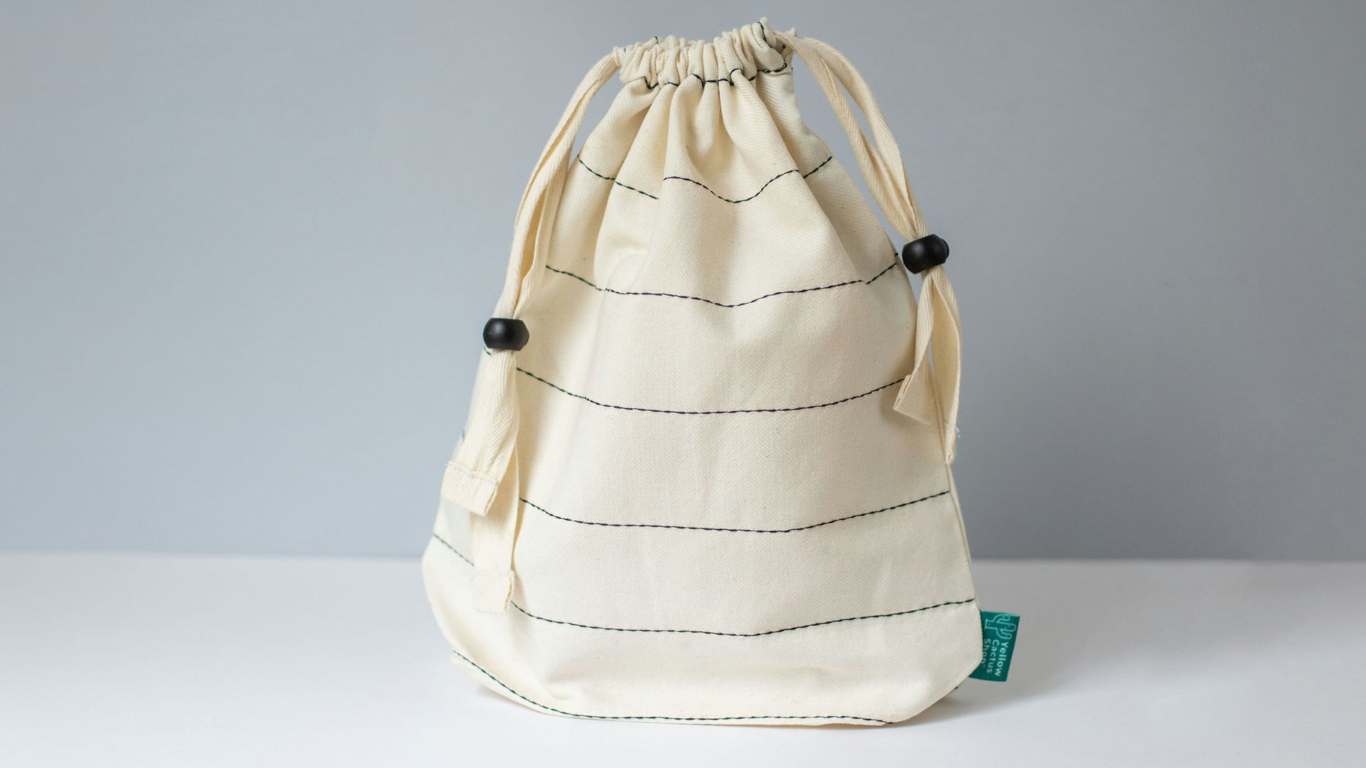 a white bag sitting on top of a white table