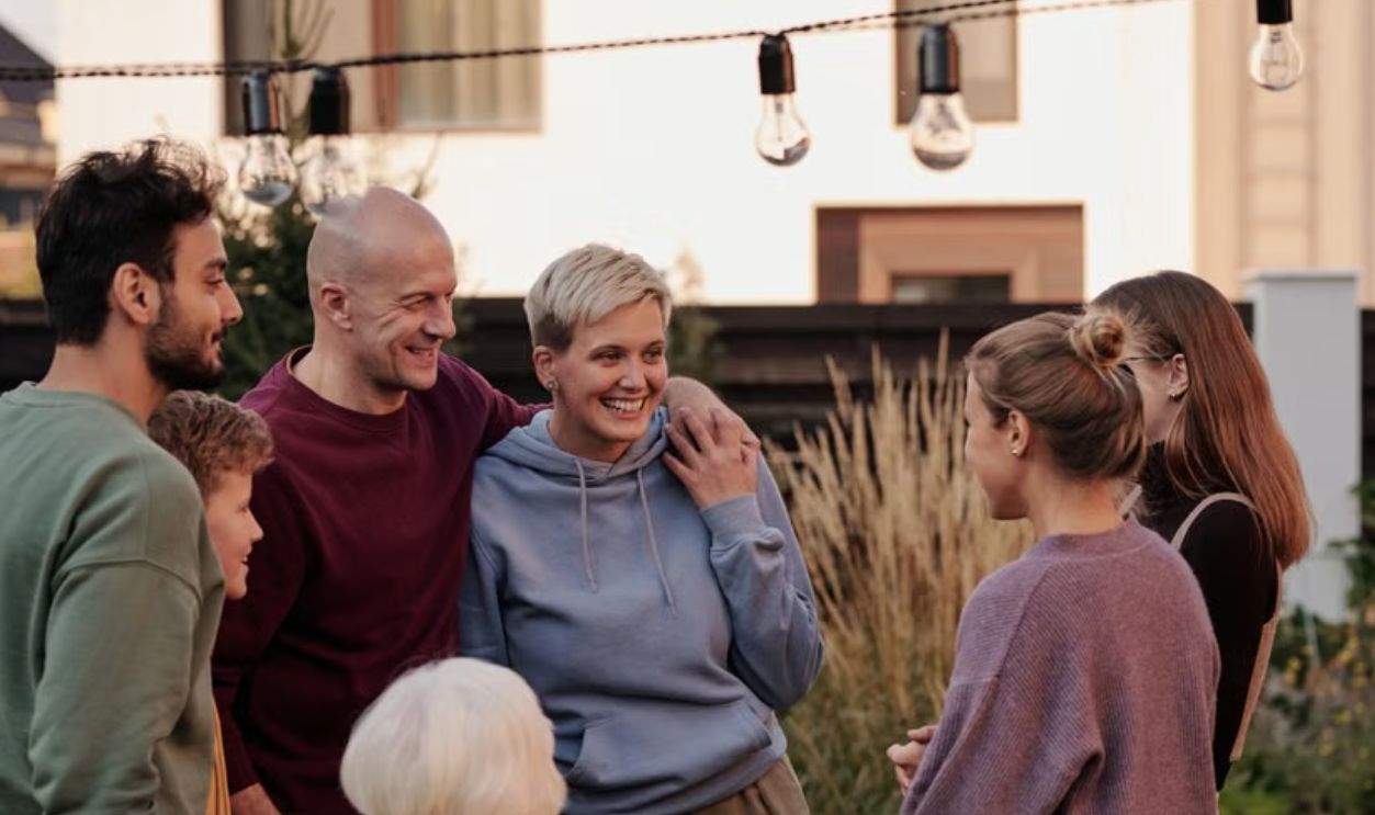 A joyful group of adults and seniors enjoying a lively garden get-together