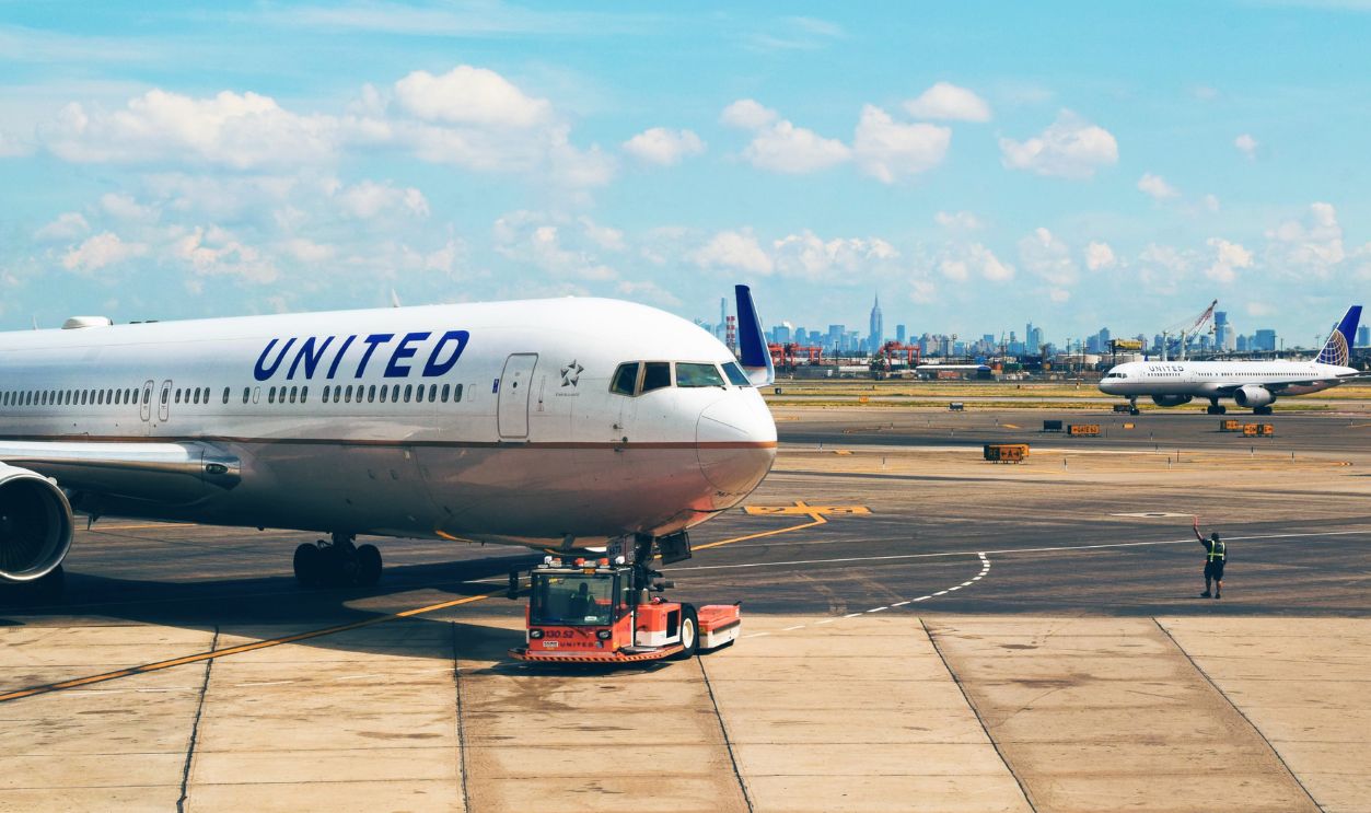 Aircraft on the runway at Newark Airport with city skyline in the background