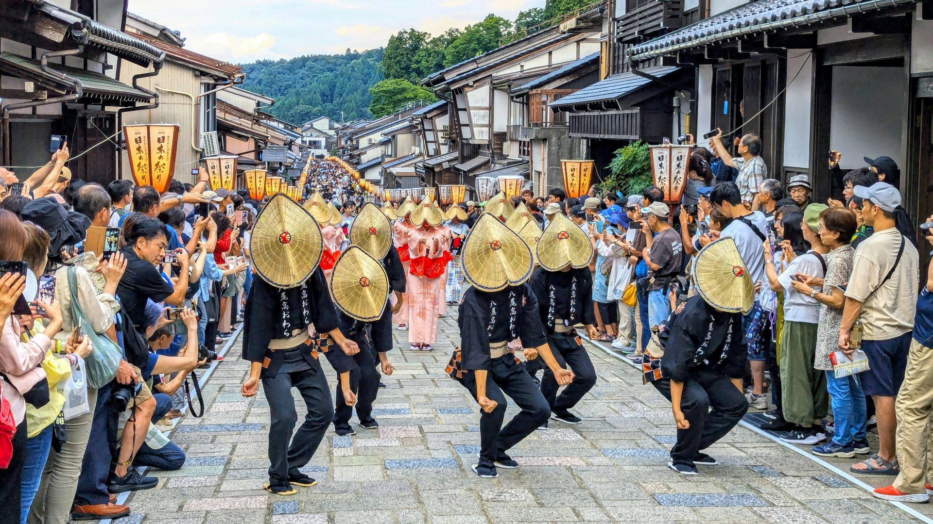 A group of people that are standing in the street