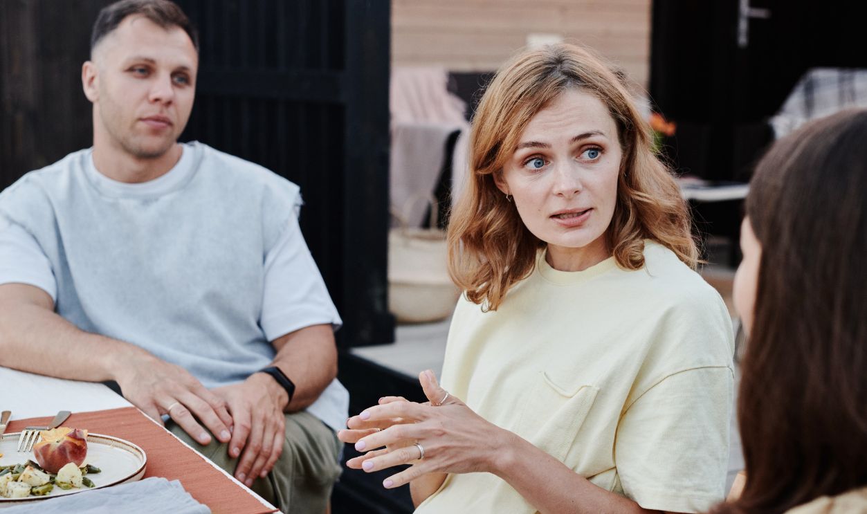 A group of adults enjoying relaxed outdoor meal together