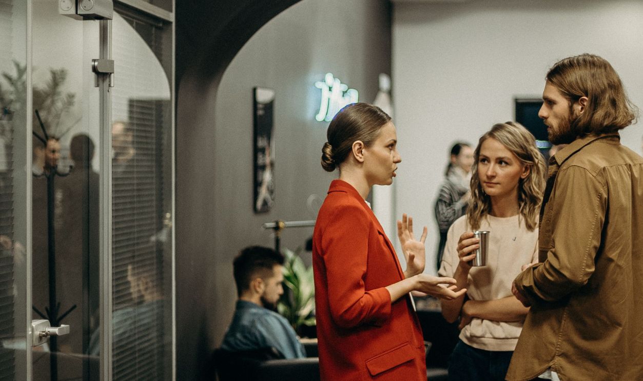 A lively casual office gathering with people engaged in conversation 