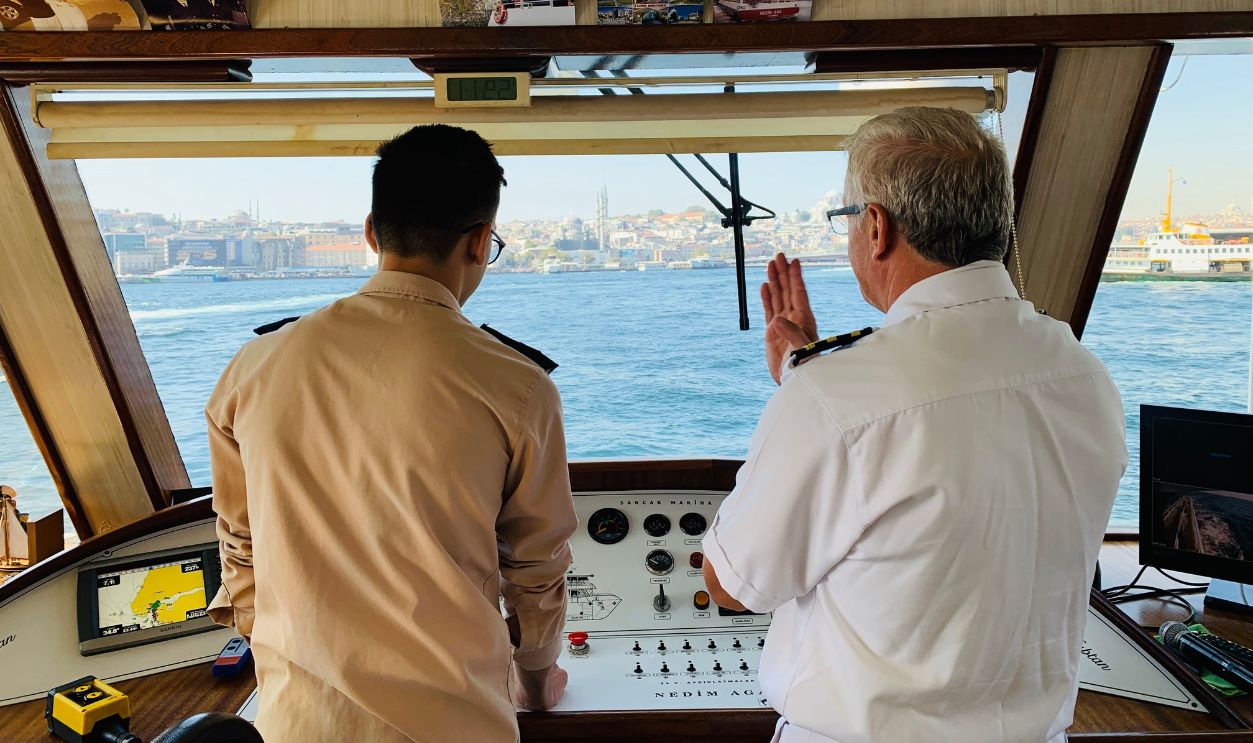 Ship captain and crew member discussing navigation on the Bosphorus 