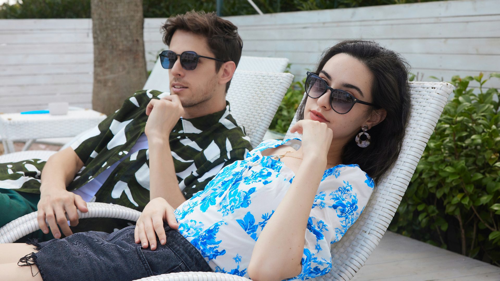 a man sitting next to a woman in a chair