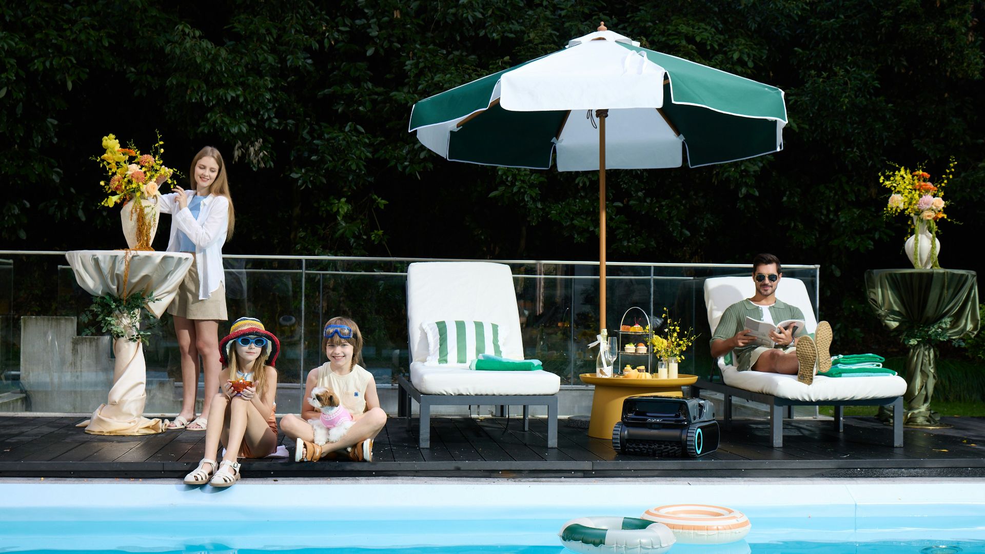 Family relaxing by a swimming pool on a sunny day.