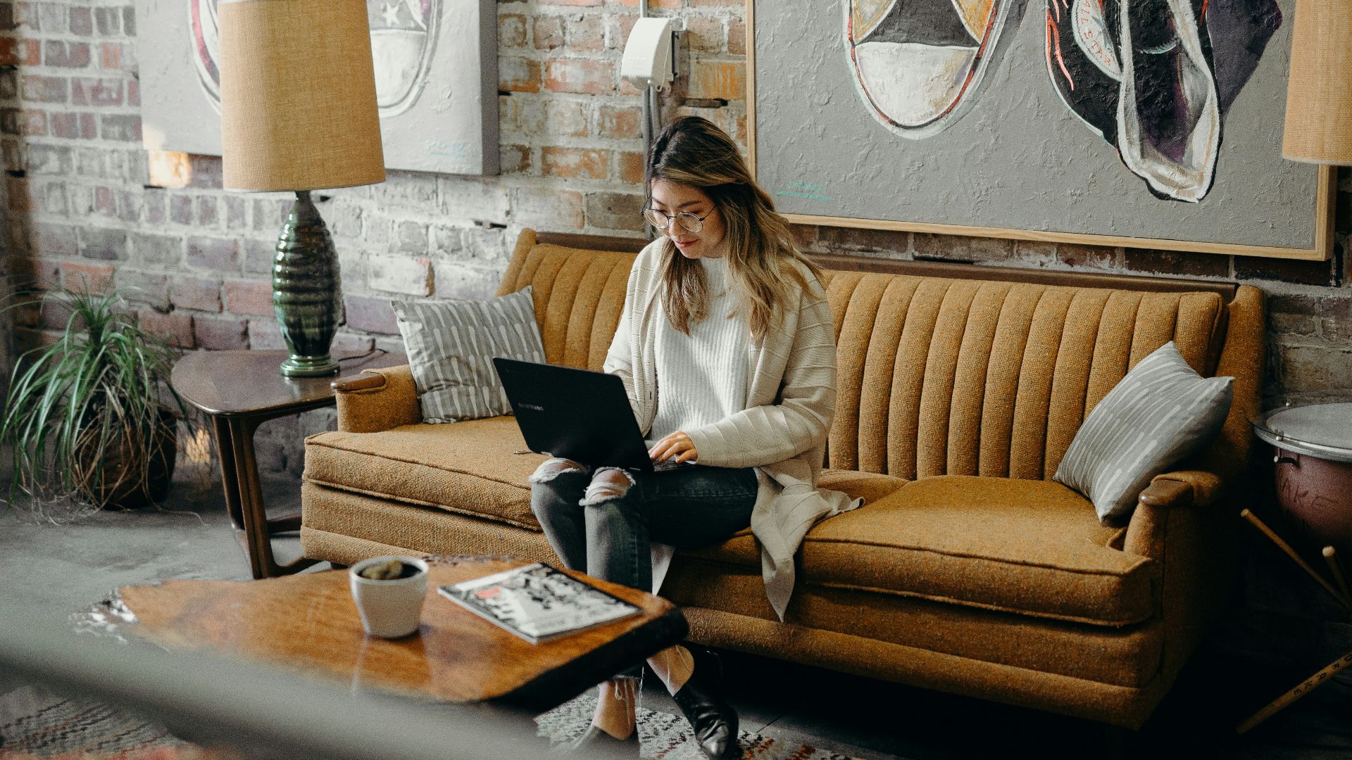 woman using laptop while sitting on chair