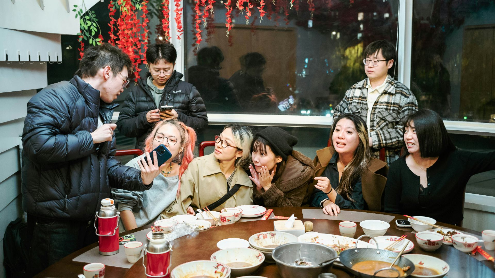 Group of friends gathered around a table for a meal.