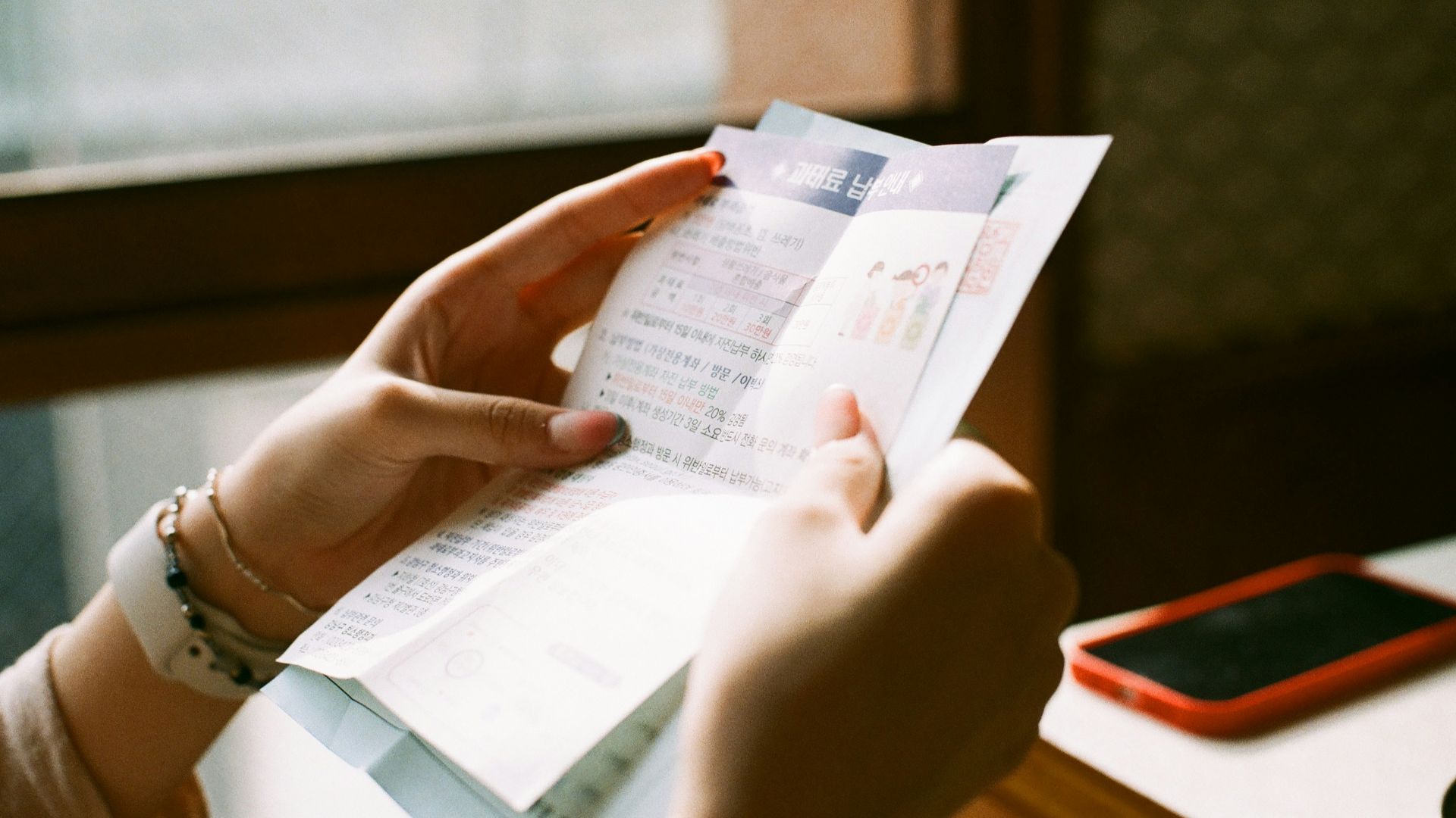 person holding white printer paper