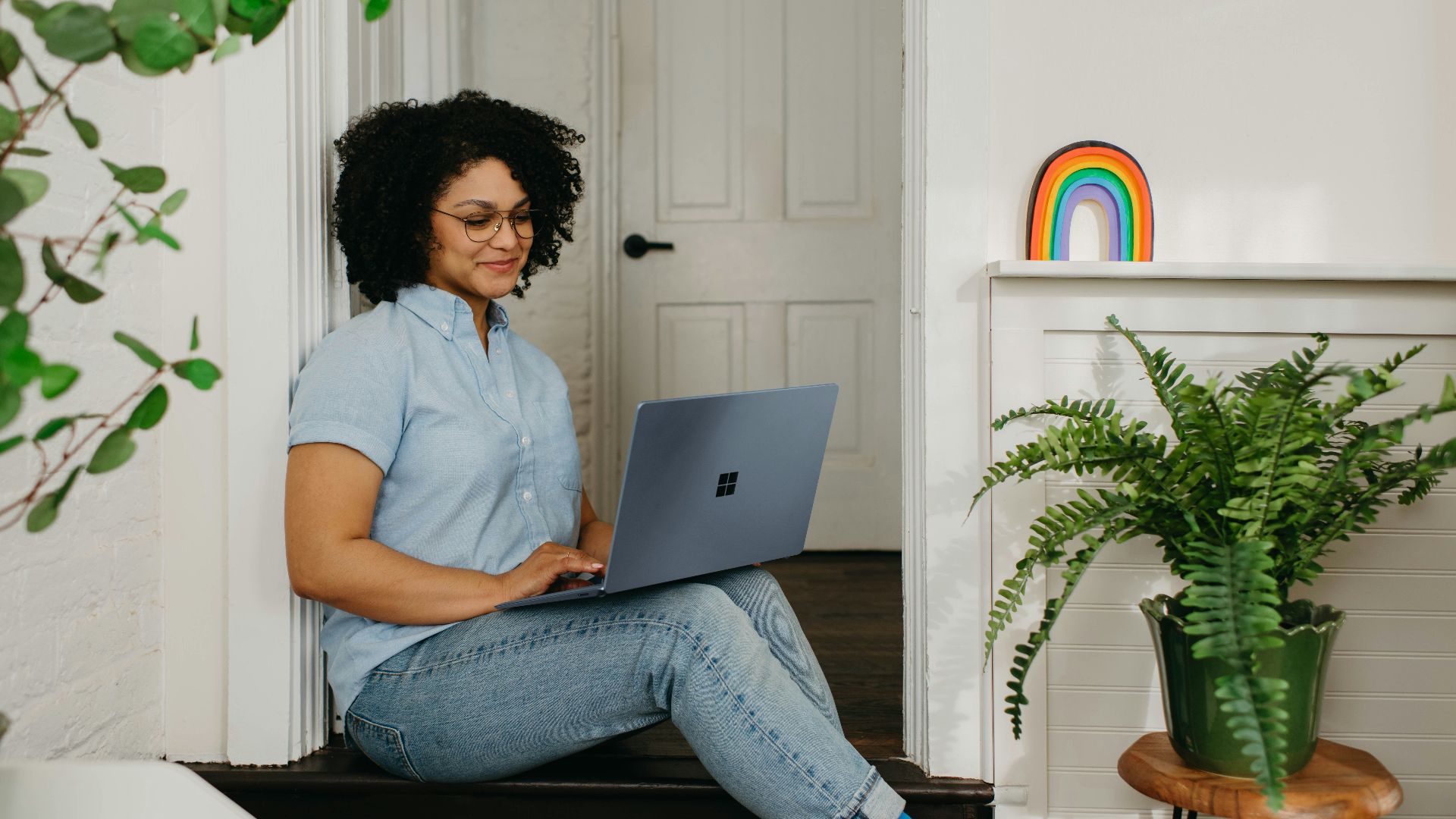a woman sitting on the floor using a laptop