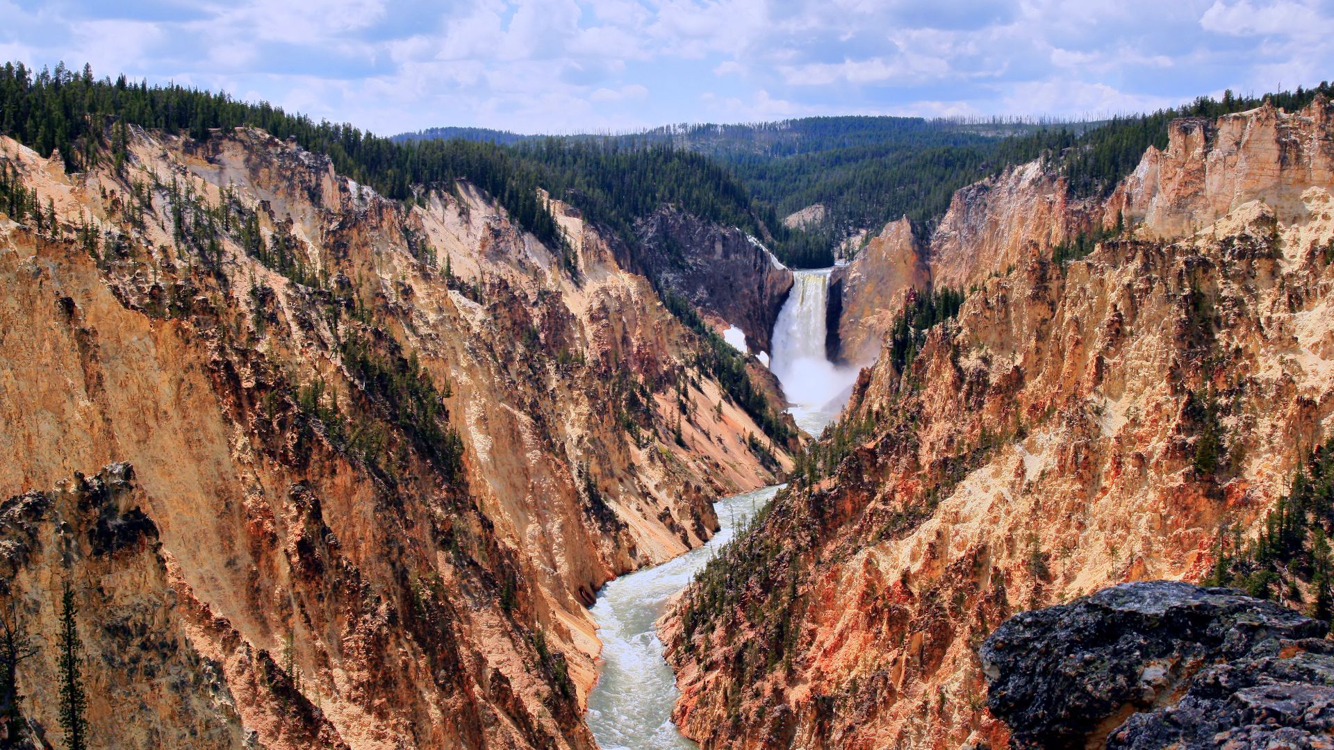 Grand Canyon and Yellowstone Fall at Yellowstone National Park. The canyon is up to 900 feet deep (275 m) and a half mile (0.8 km) in width. The canyon below the Lower Yellowstone Falls was at one time the site of a geyser basin that was the result of w:r