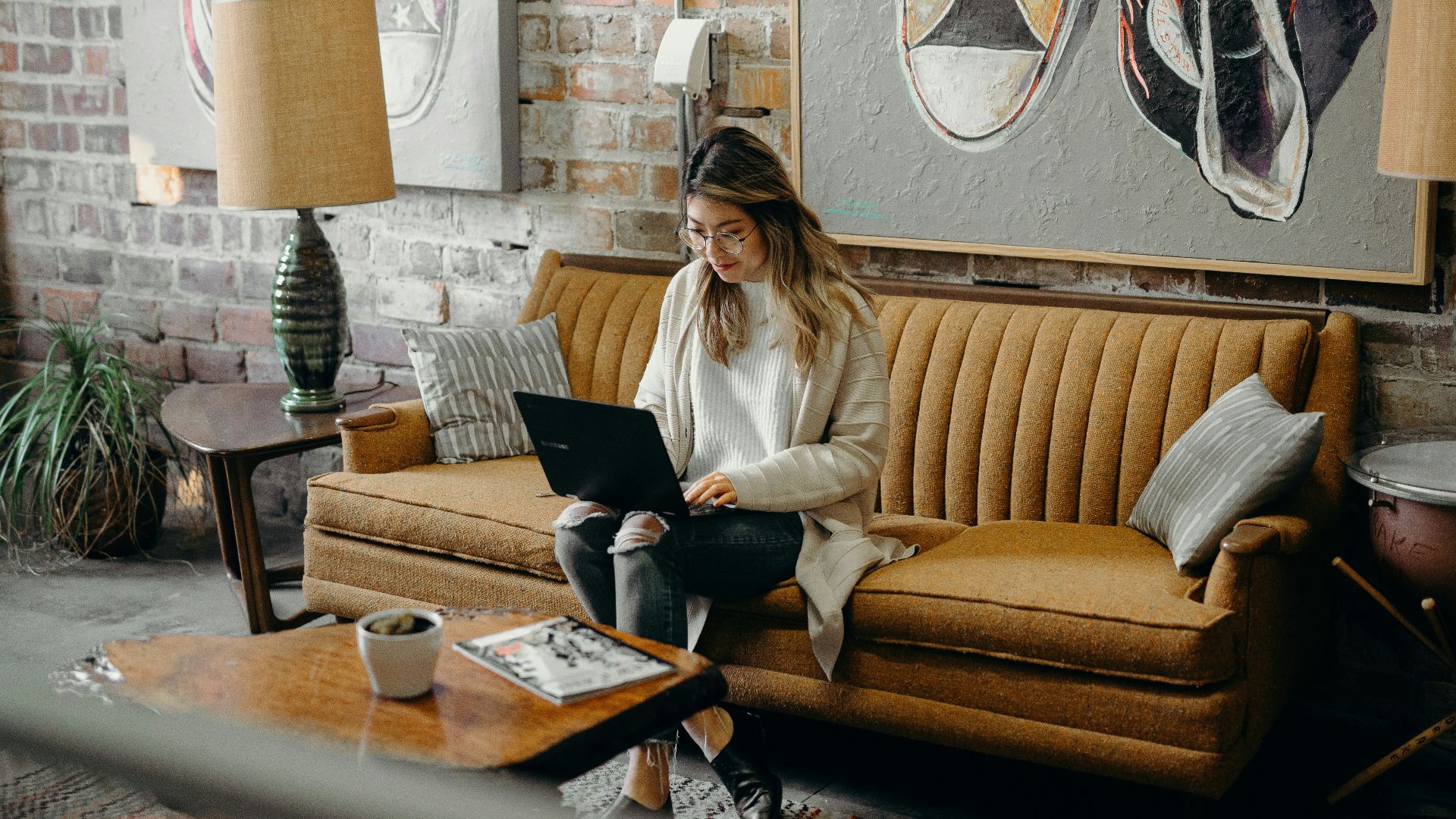 woman using laptop while sitting on chair