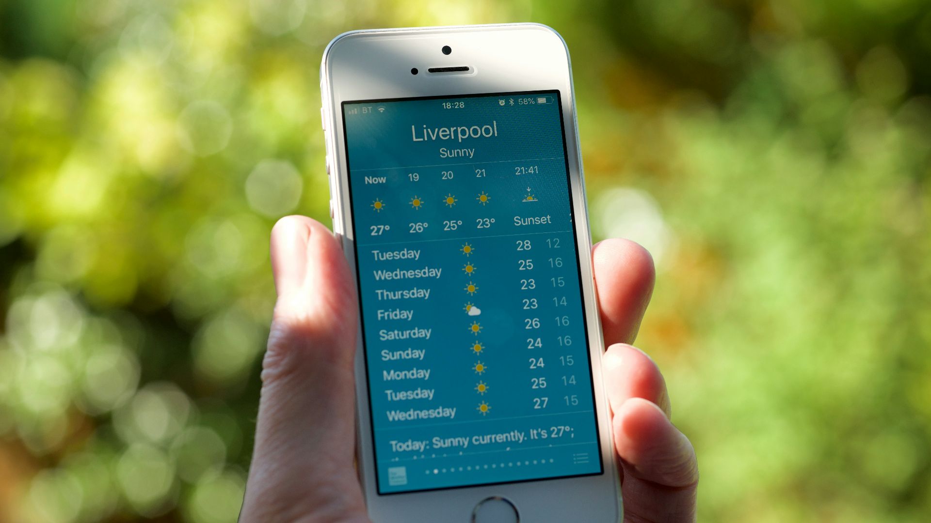 person holding turned on silver iPhone 5s displaying liverpool