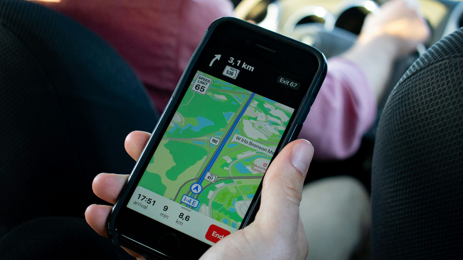 a person holding a cell phone in their hand