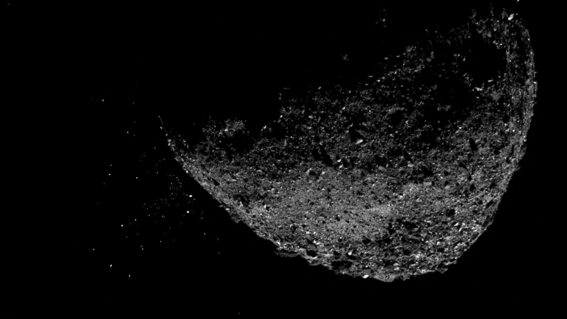 This view of asteroid Bennu ejecting particles from its surface on Jan. 6, 2019, was created by combining two images taken by the NavCam 1 imager aboard NASA's OSIRIS-REx spacecraft: a short exposure image, which shows the asteroid clearly, and a long-exp