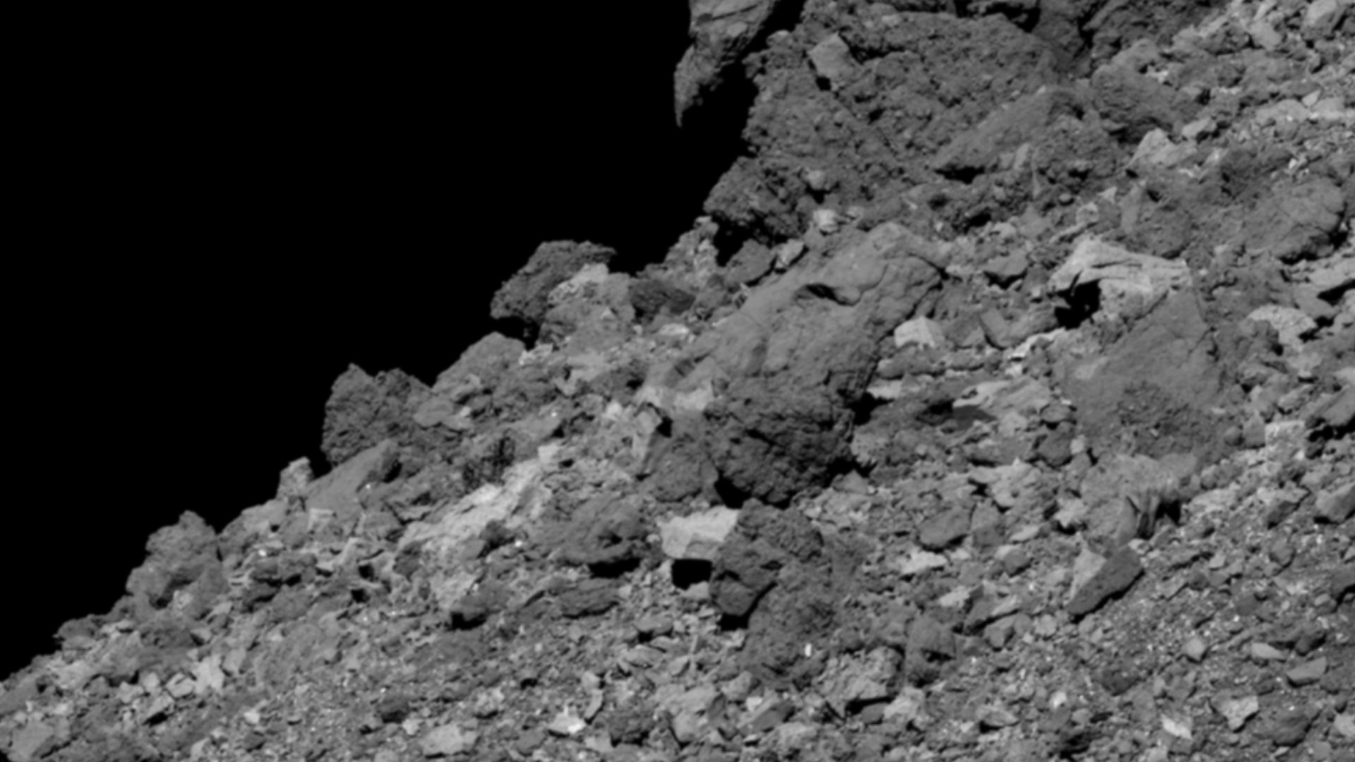 This image shows asteroid Bennu’s boulder-covered surface. It was taken by the PolyCam camera on NASA’s OSIRIS-REx spacecraft on April 11, 2019, from a distance of 2.8 miles (4.5 km). The field of view is 211 ft (64.4 m), and the large boulder in the uppe