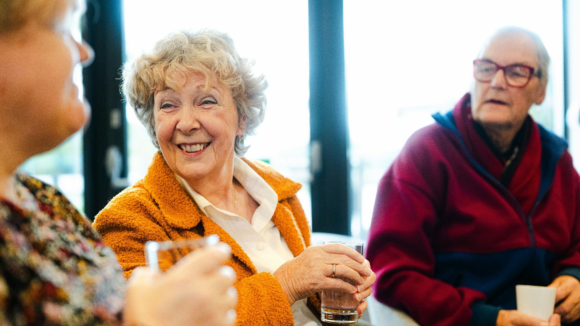 Three seniors talking and smiling together