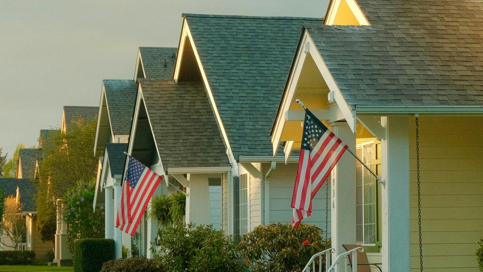 a row of houses with american flags on them