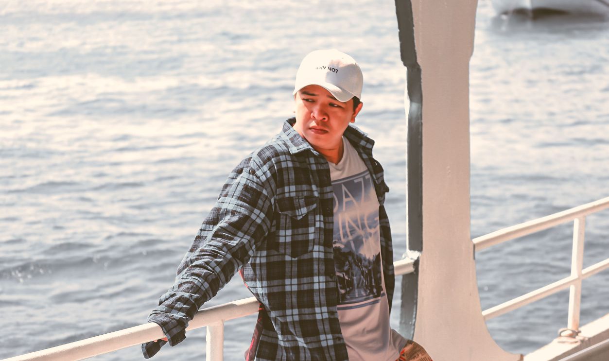 A young man enjoying a casual moment on a boat 