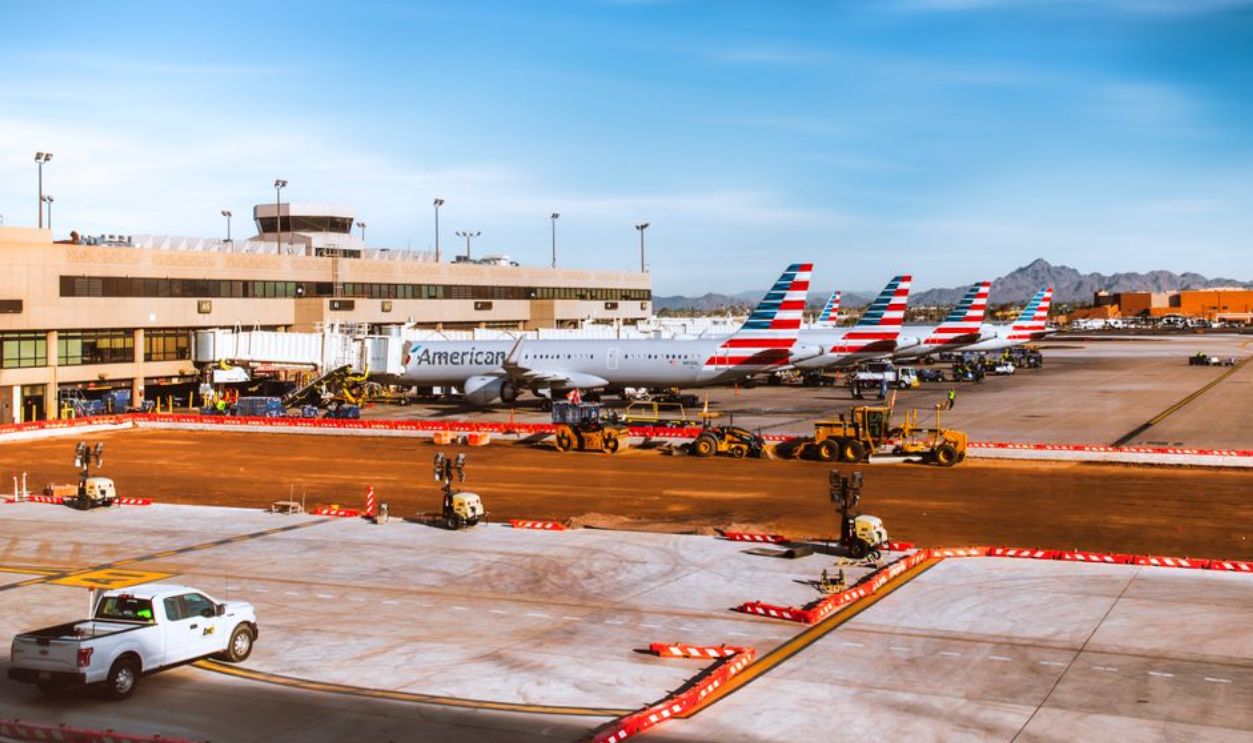 Line of American Airlines planes at Phoenix Sky Harbor with mountains in background