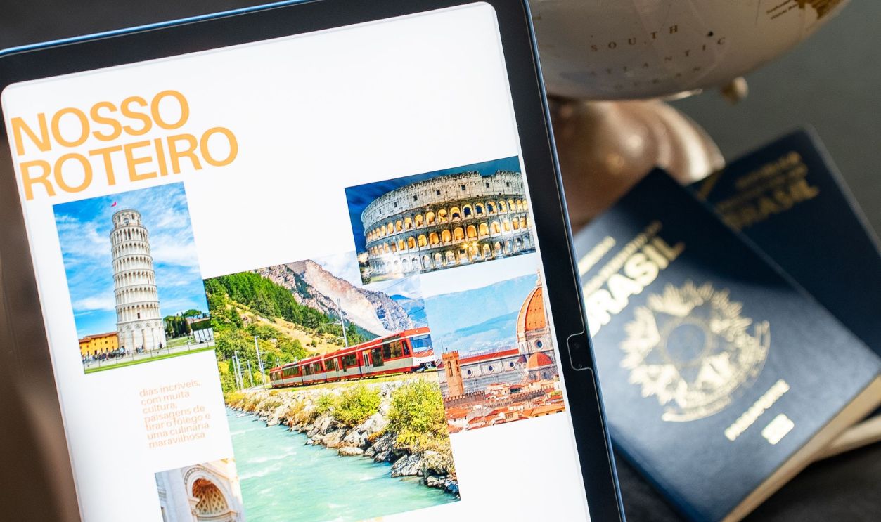Person planning a trip to Italy and Switzerland using a tablet and globe