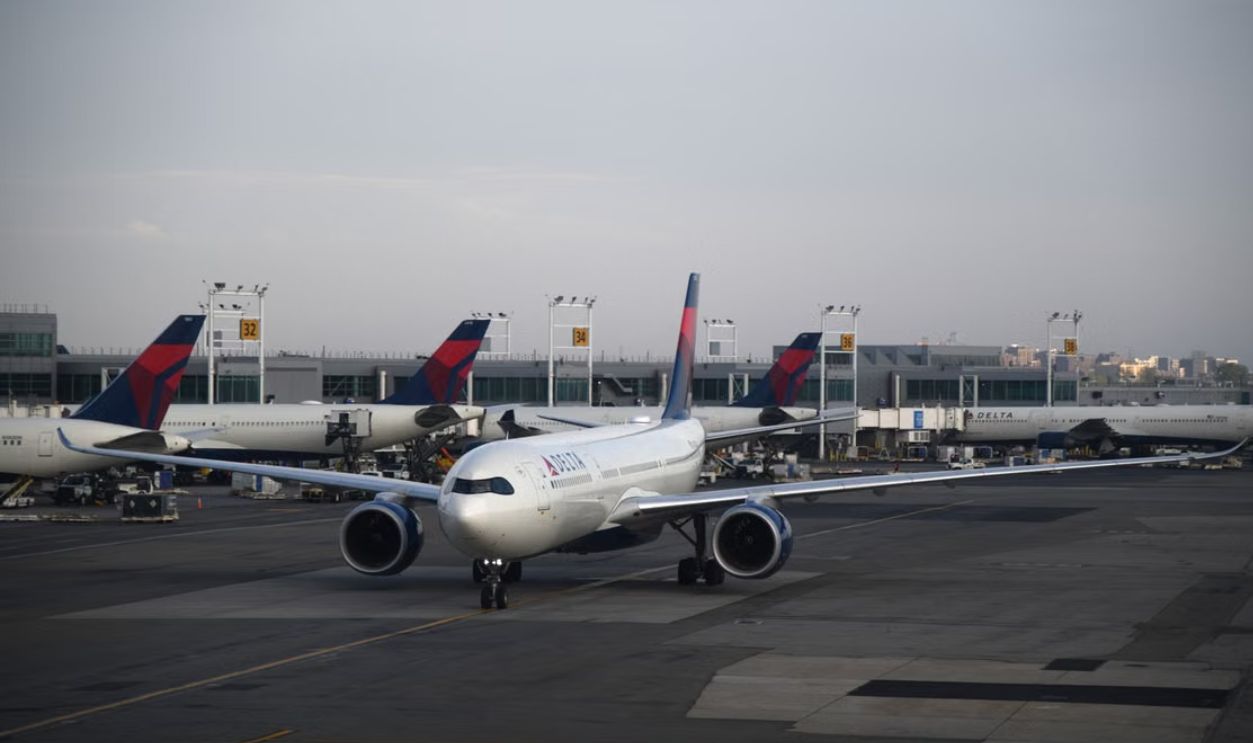 A commercial airplane on the runway at a New York airport during the day