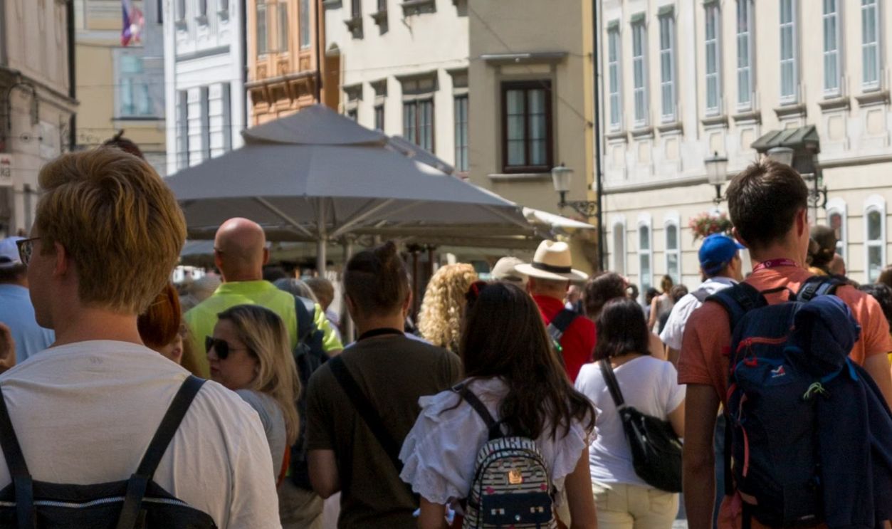 A lively European street scene with tourists exploring historic architecture