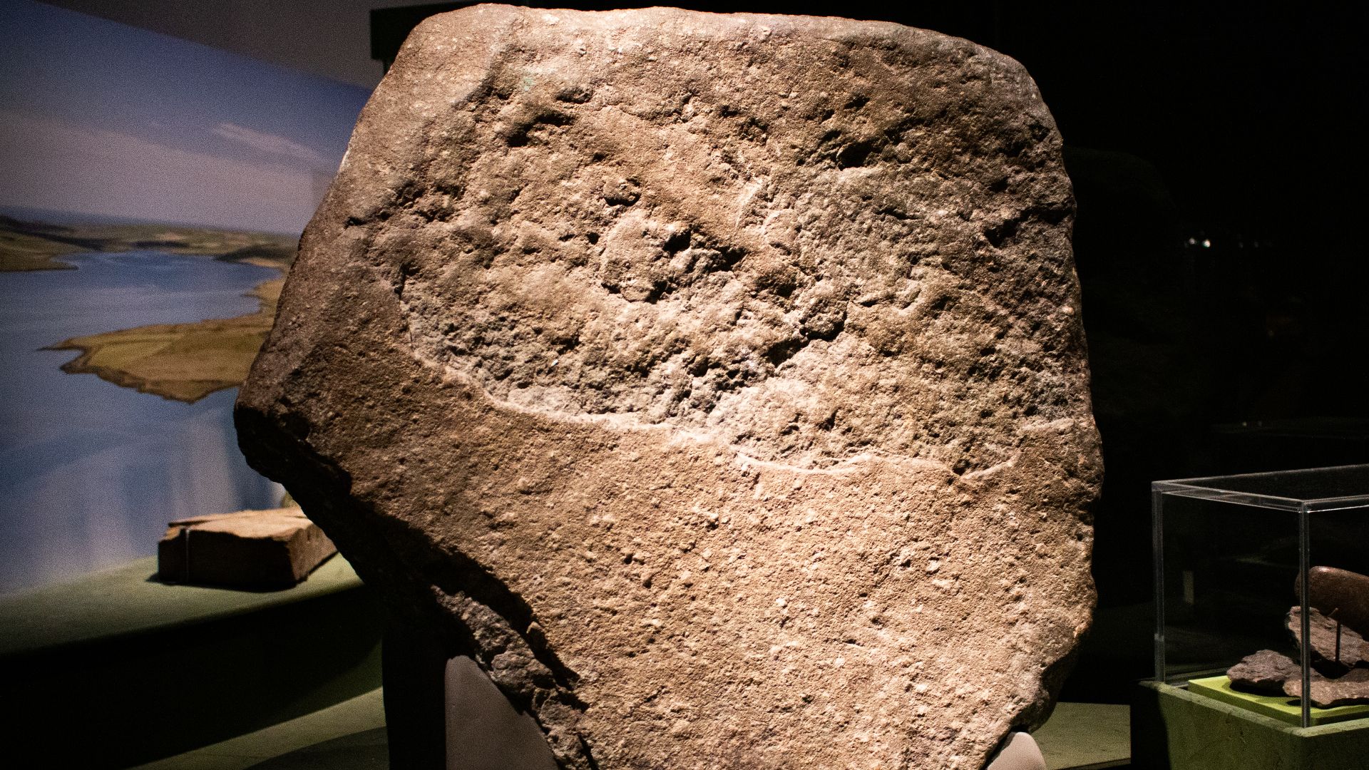 A large piece of dressed Welsh bluestone, likely to have been part of the first monument at Stonehenge. The stone is here on display at the British Museum in their World of Stonehenge exhibition.