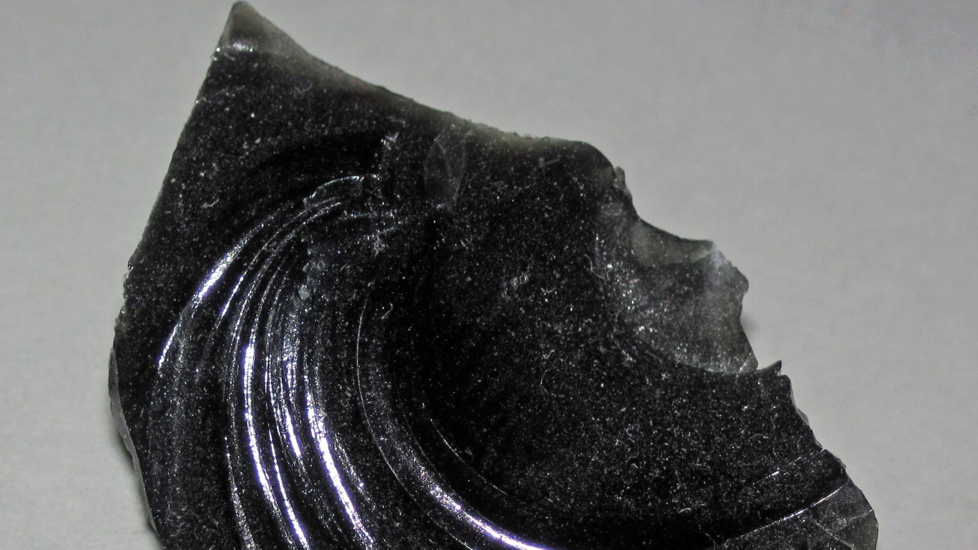 (~2.5 centimeters across along the base)

Igneous rocks form by the cooling & crystallization of hot, molten rock (magma & lava).  If this happens at or near the land surface, or on the seafloor, they are extrusive igneous rocks.  If this happens deep und